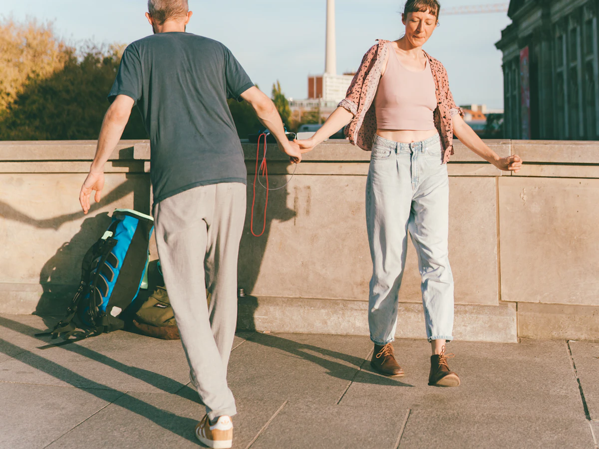 A couple holding hands with the Berlin television tower in the background